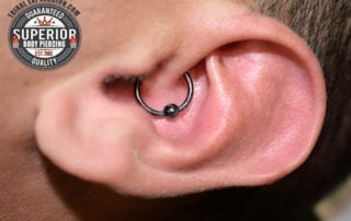 Daith piercing with a 16g Tribal Expression Niobium captive bead ring