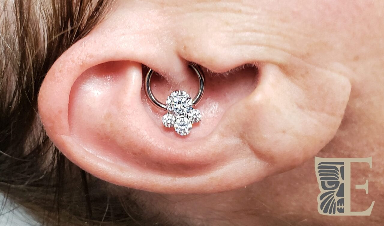 Daith pierced with an Industrial Strength 4 CZ gem cluster on a titanium captive bead ring