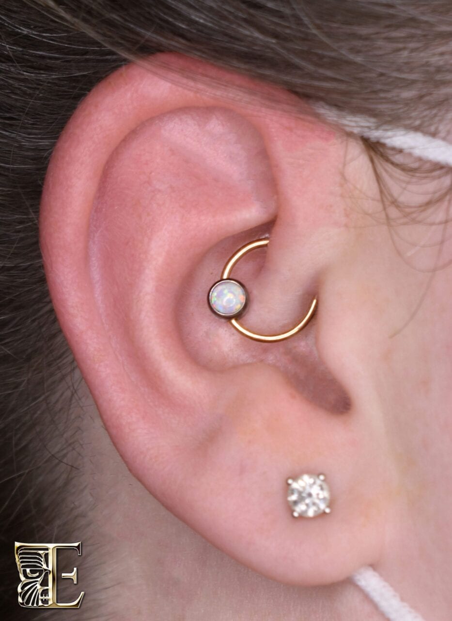 Daith pierced with a Tribal Expression 14k yellow gold captive bead ring and a 5mm opal bead