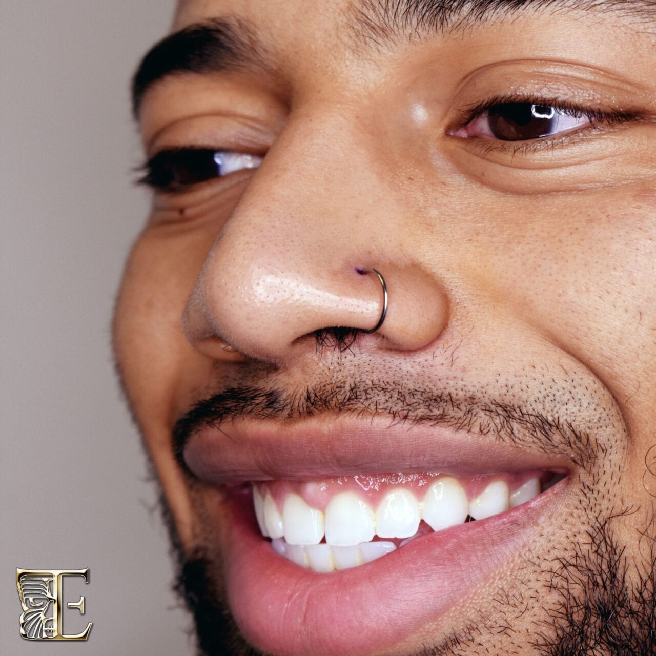 Nostril pierced with a Tribal Expression titanium captive bead ring