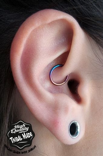 Daith insert with a 16g titanium hinged seam ring anodized rainbow