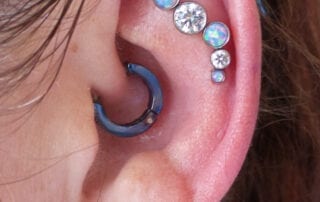 Floating industrial piercing with a CZ and Opal double threaded curved cluster from Industrial Strength