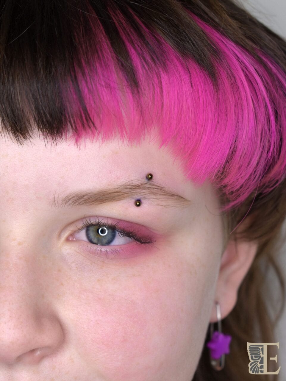 Bronze Middle brow Eyebrow pierced with a 16g TE titanium curved barbell anodized bronze