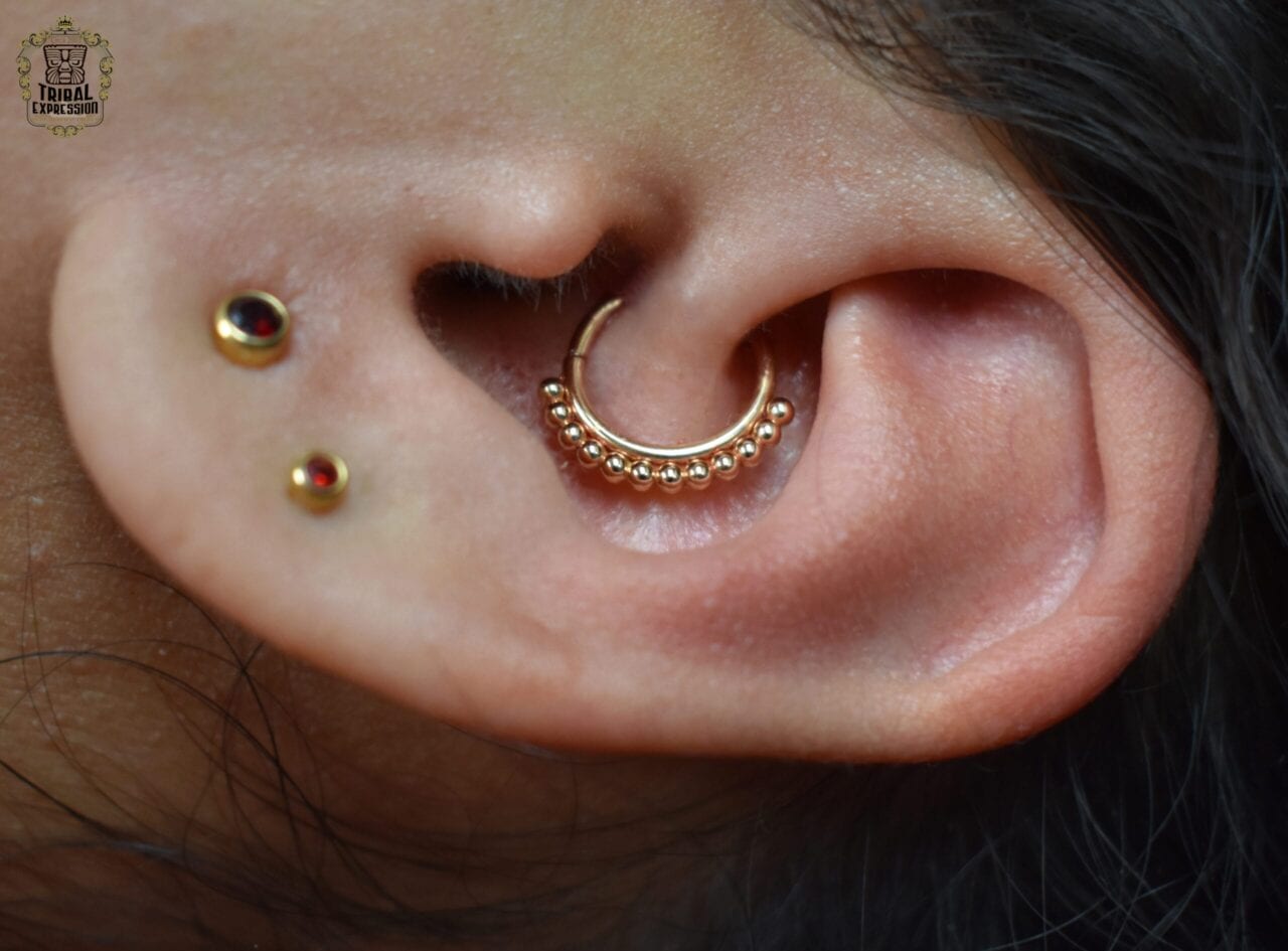 Daith piercing with a 16g 14k yellow gold Vaughn seamring from Anatometal