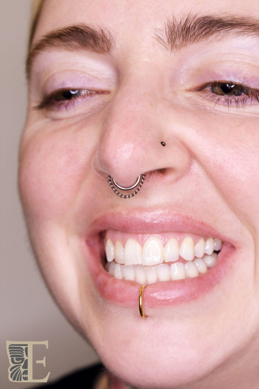 Smiling Septum Piercing with High-Polish Ring – Tribal Expression Calgary Forward-facing photo of a happy, smiling client with a beautifully centered septum piercing and a high-polish ring, professionally done at Tribal Expression body piercing studio in Calgary
