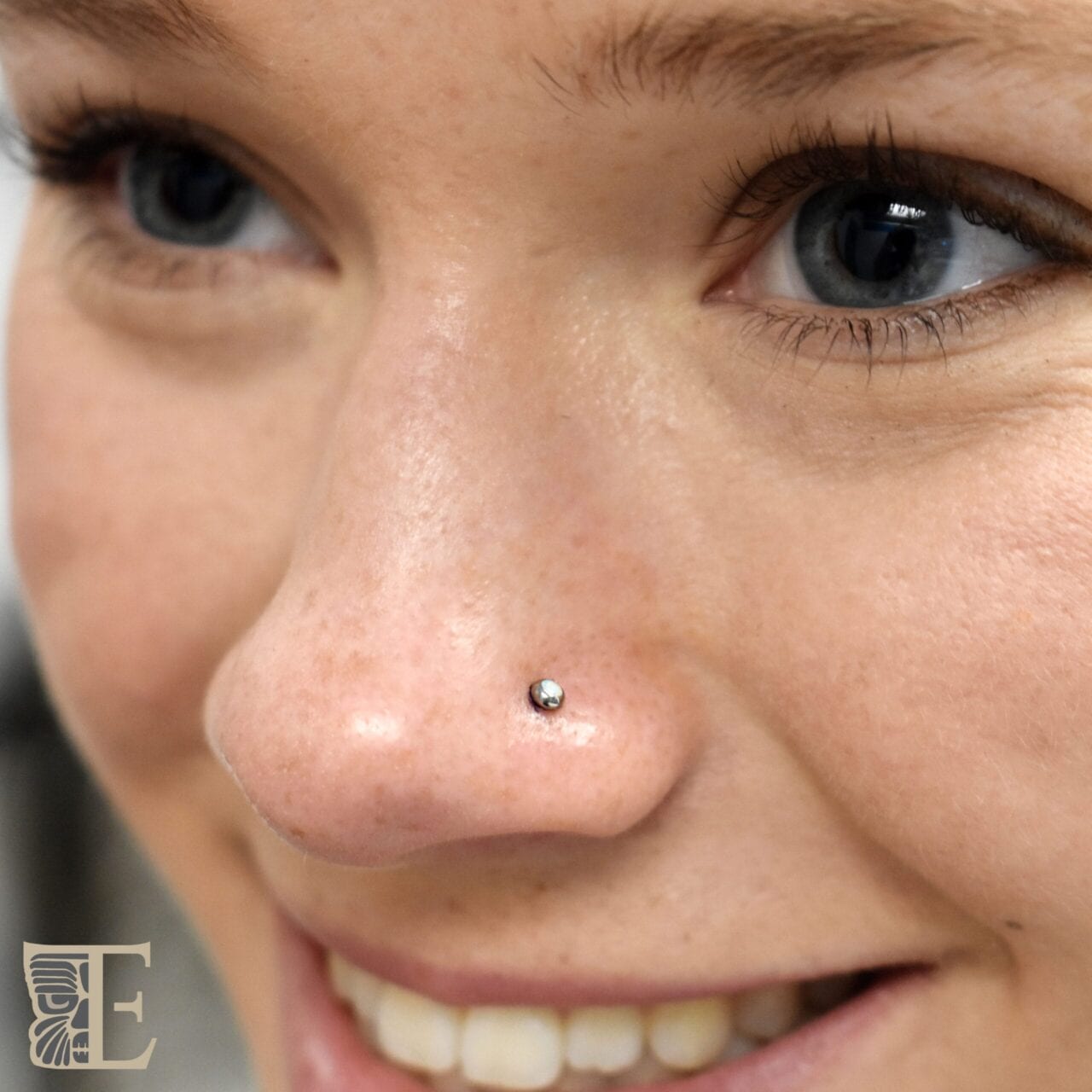 Nostril pierced with a threadless titanium 2.5mm white synthetic opal from Tribal Expression