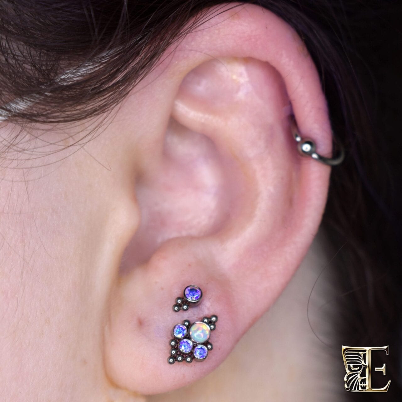 Stacked lobe piercing with 14g titanium opal and faceted gem threaded ends from LeRoi