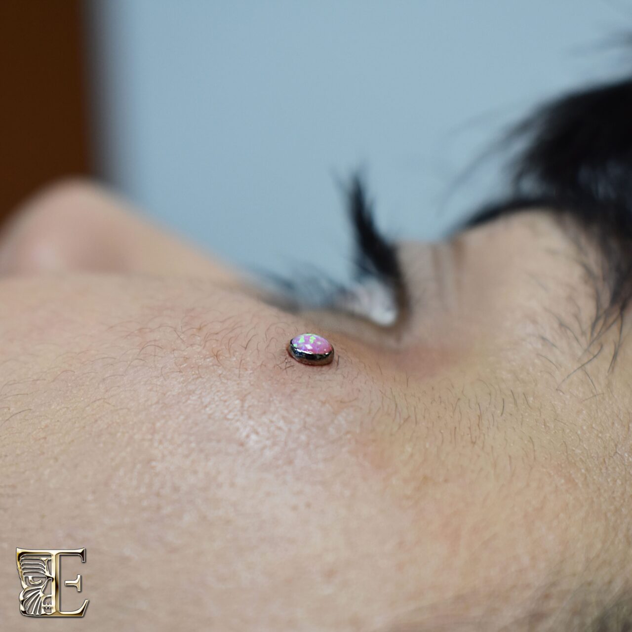 Anti-eyebrow dermal anchor with a Tribal Expression 4mm pink opal bead