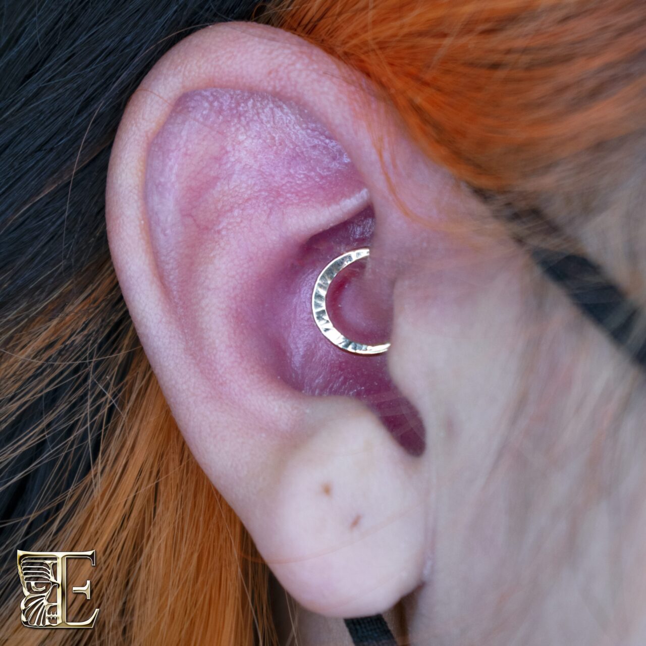 Daith piercing with a 14k gold hammered seam ring from Tribal Expression
